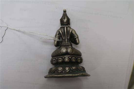 A white metal Buddha